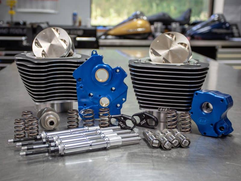High-performance motorcycle engine parts, including cylinders, pistons, and accessories.