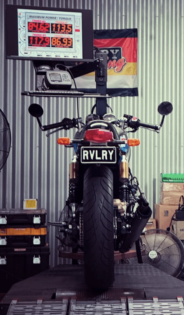 High-performance motorcycle at Revelry Cycles with custom branding and racing setup, ready for the track.